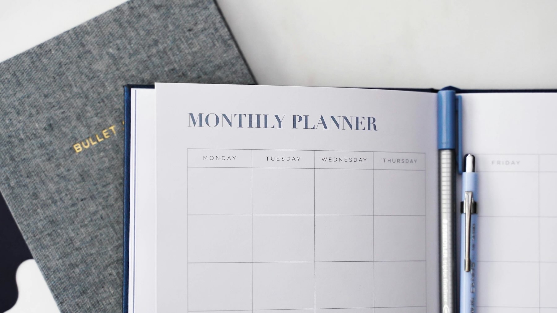 Calendar showing 2026 next to a laptop displaying a modern website refresh plan