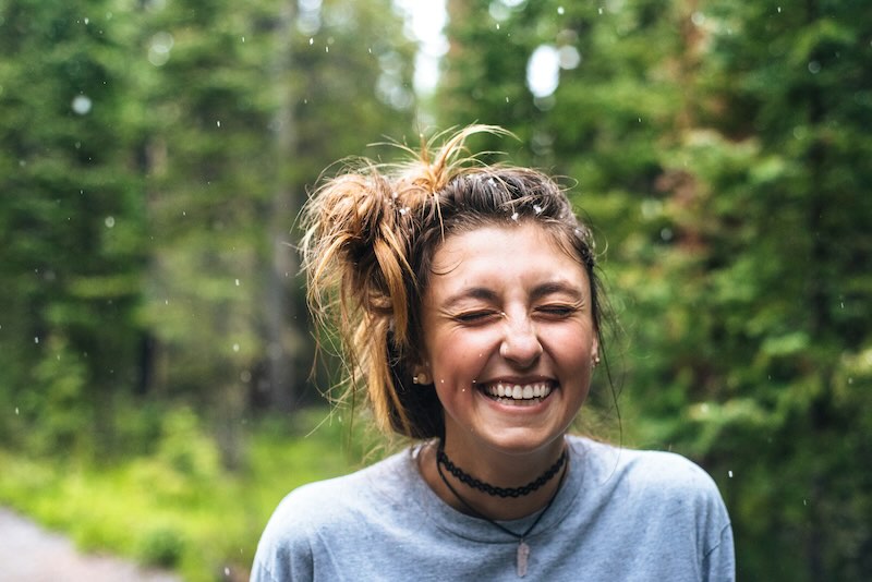 Smiling woman outdoors with a bright, confident smile